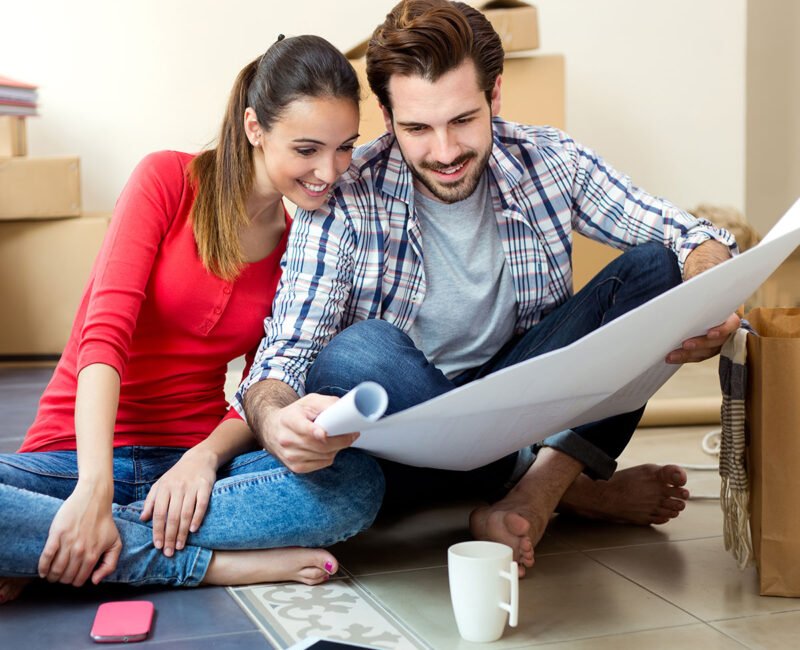 Movers reviewing a moving plan with a customer