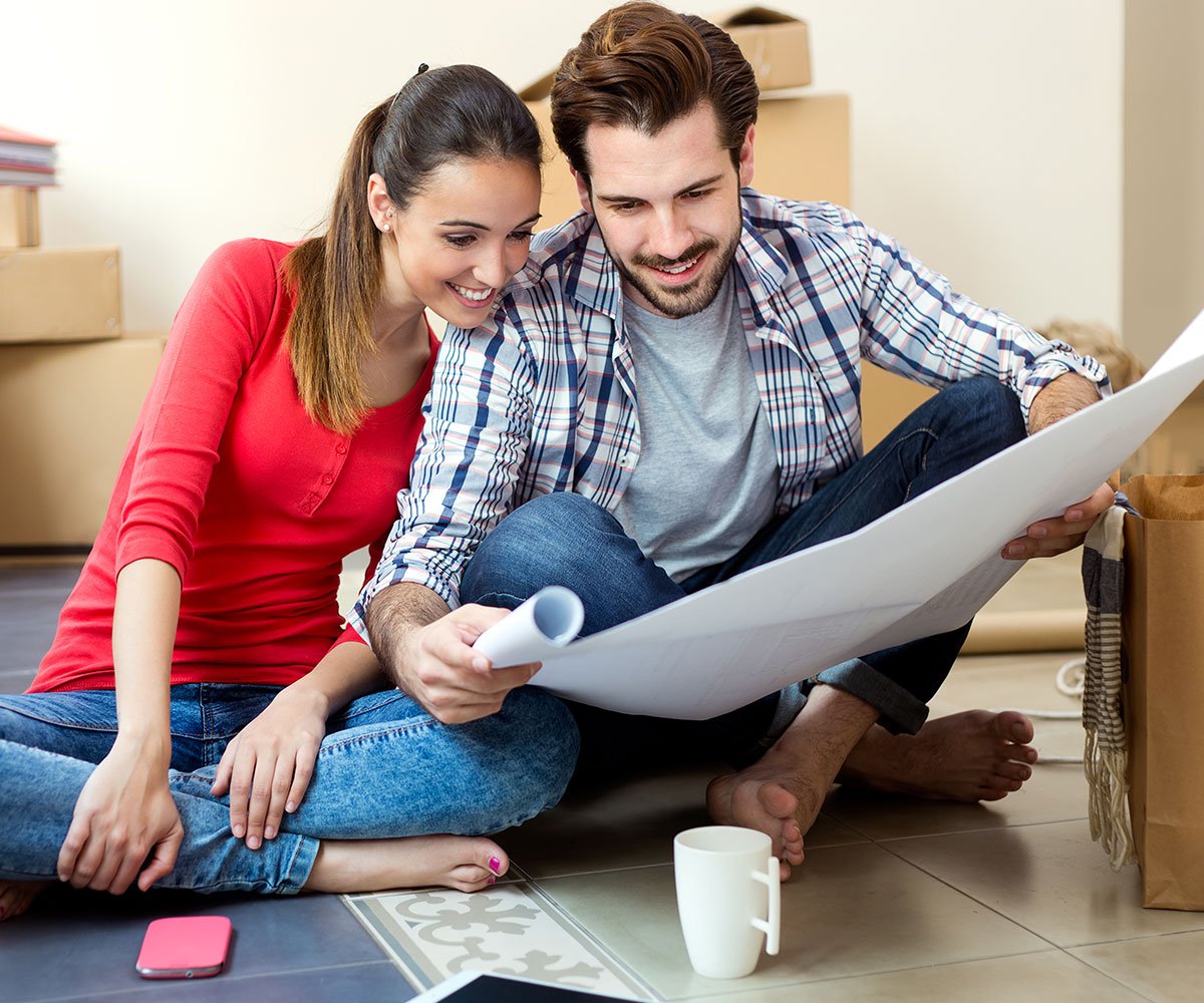 Movers reviewing a moving plan with a customer